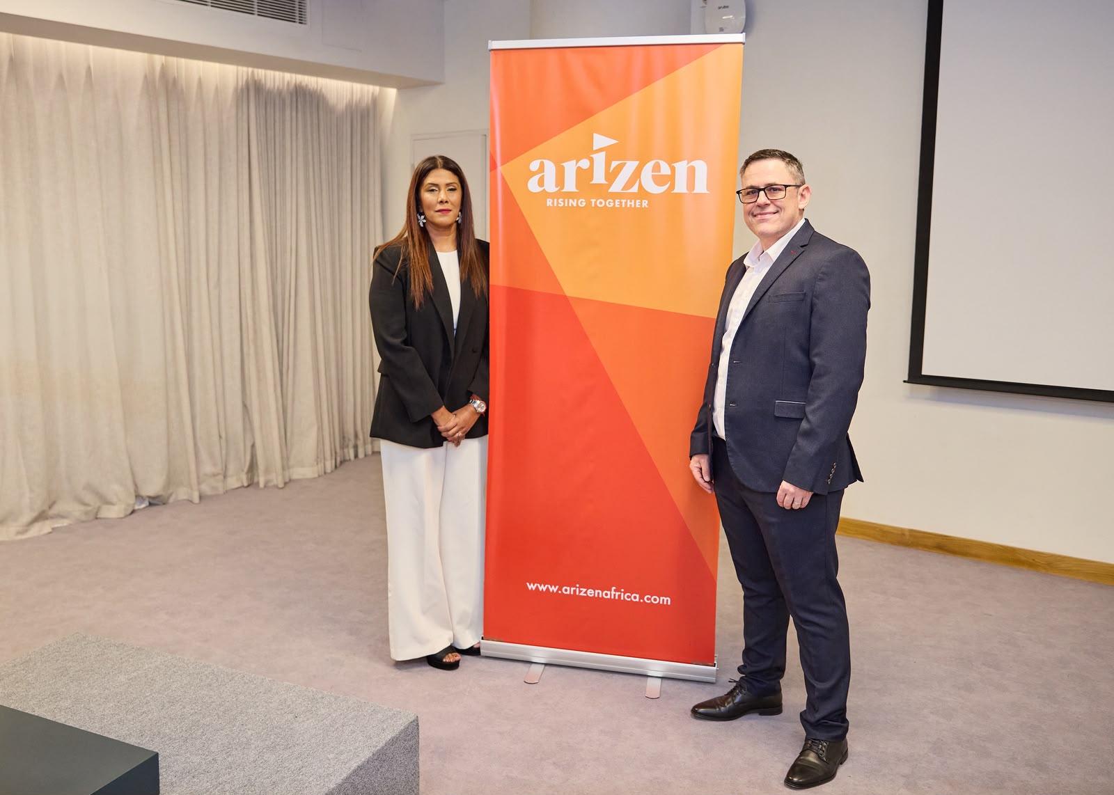Kevina Takoordyal and Hugo Jordaan beside the Arizen banner