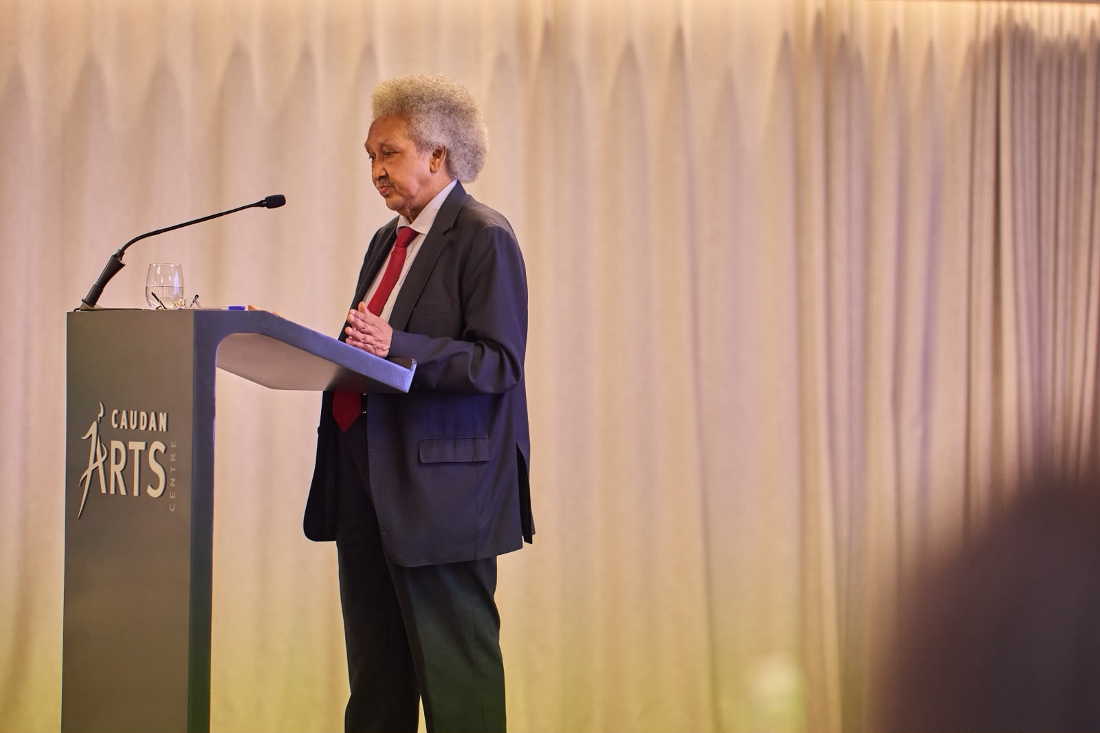 Guest speaker addressing the audience at Caudan Arts Centre